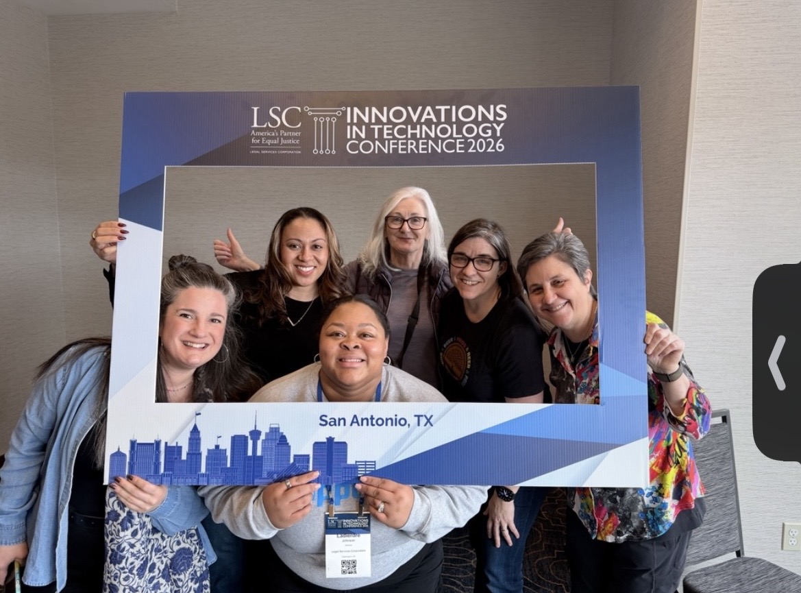 Conference attendees posing together with the blue and white ITC 2026 photo frame in San Antonio
