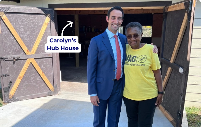 Carolyn standing with another person outside her hub house